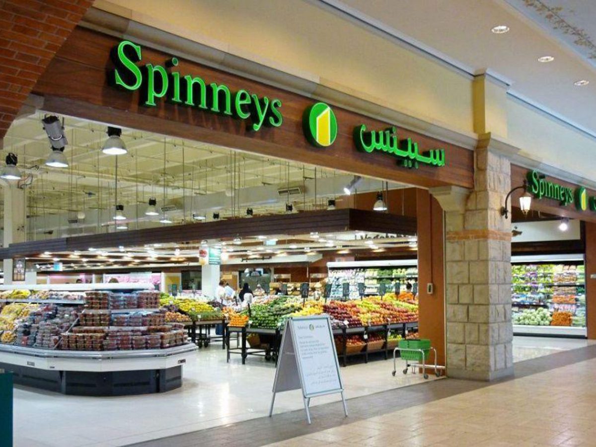 Spinney's removes plastic bags in Abu Dhabi stores: Spinneys storefront inside with produce stands