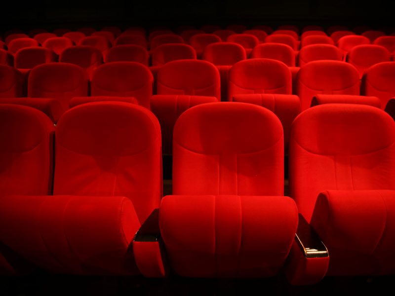 UAE face mask rules: dark movie theatre with red seats