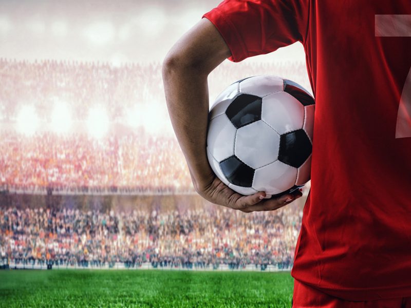 UAE football stadium: Soccer player holding soccer ball in stadium