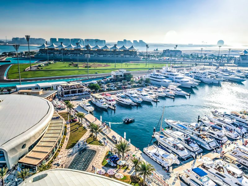 Yas Marina promenade: sunny blue sky with boats in harbour