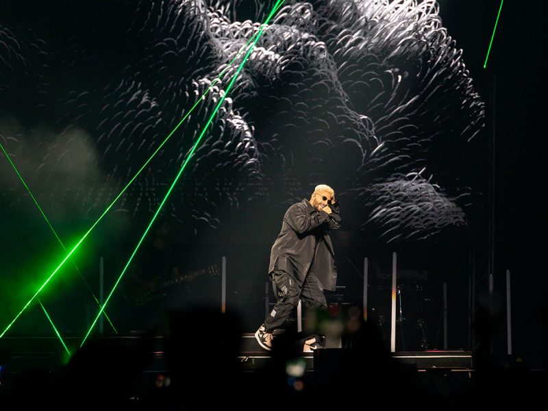 Maluma in concert: man performing on stage with green lights