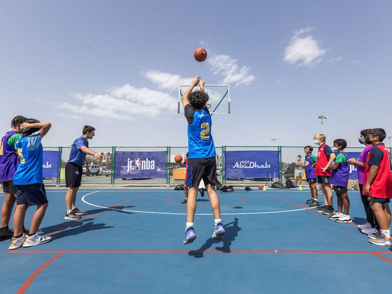 Jr. NBA players shooting basketball hoops