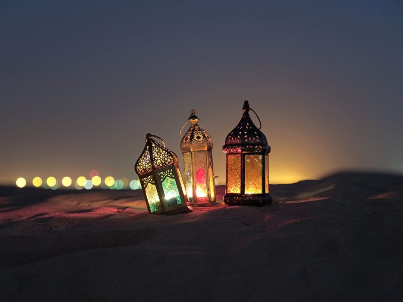 Ramadan 2022 iftar tent setup guidelines: colourful lanterns in the desert sand at night